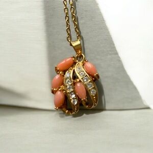 Coral (?) and rhinestone gold tone pendant pink stones